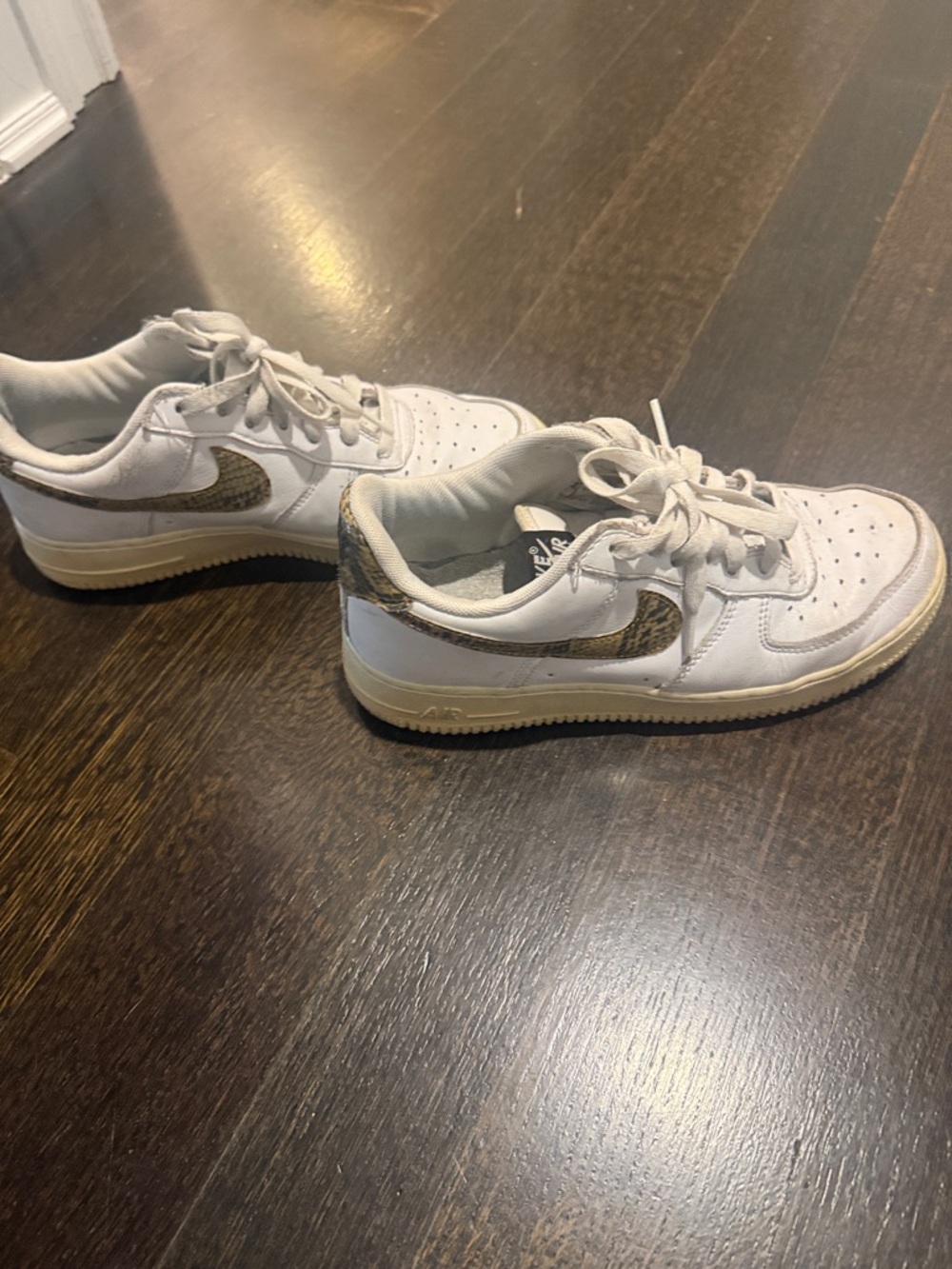 Nike men’s White Air Force 1 Sneakers with Snake-Print Swoosh Accent
